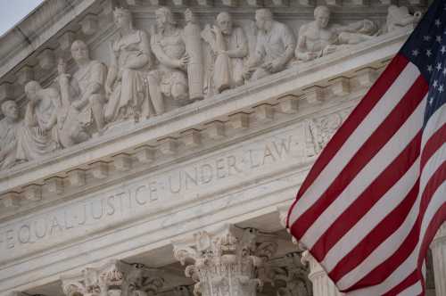 A detail view of the U.S Supreme Court and an American Flag, in Washington, D.C., on Friday December 10, 2021. REUTERS/Graeme Sloan/Sipa USA