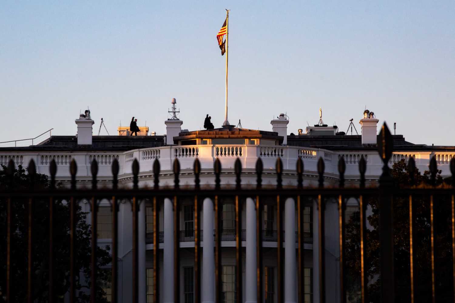 Snipers are seen walking on the roof of the White House in Washington, D.C. at sunset on February 9, 2022 (Photo by Bryan Olin Dozier/NurPhoto)