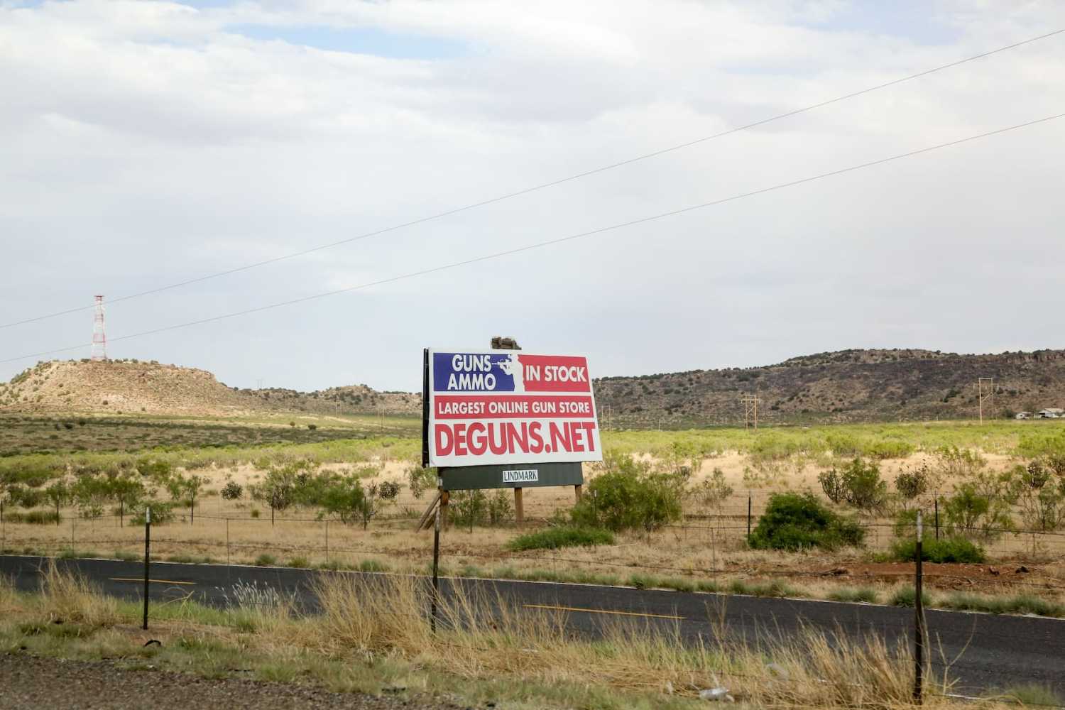 A sign advertising an online gun store is seen off I-40 in New Mexico USA on June 13, 2022. Hundreds of stores sell guns from big chains to small independent shops. In addition, there are dozens of gun shows that take place across the nation almost every weekend. (Photo by: Alexandra Buxbaum/Sipa USA)