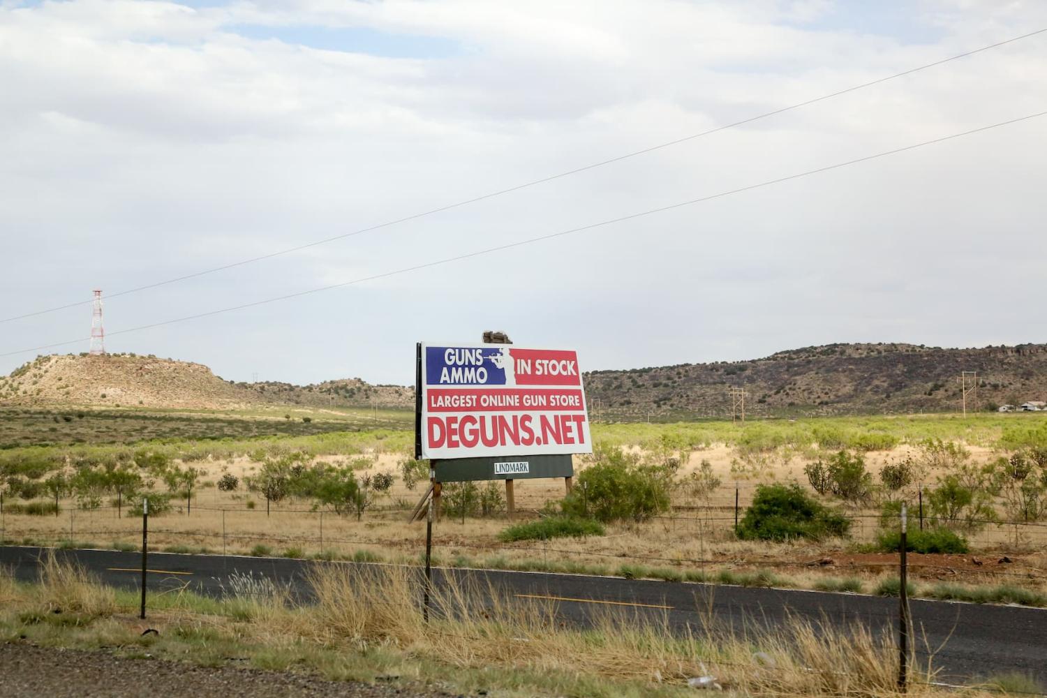 A sign advertising an online gun store is seen off I-40 in New Mexico USA on June 13, 2022. Hundreds of stores sell guns from big chains to small independent shops. In addition, there are dozens of gun shows that take place across the nation almost every weekend. (Photo by: Alexandra Buxbaum/Sipa USA)