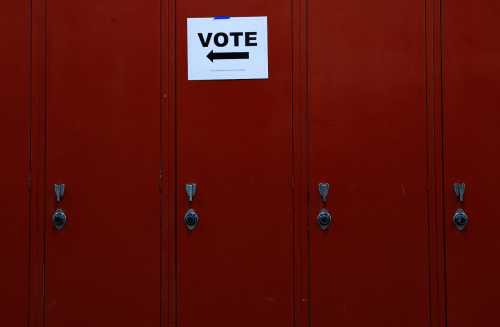 A sign points voters in the right direction for Wisconsin's Supreme Court election, at Milwaukee Marshall High School in Milwaukee, Wisconsin, U.S., April 4, 2023. REUTERS/Evelyn Hockstein