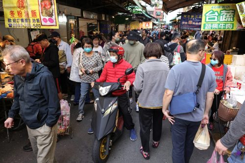People walk at Hulin Market, in Taipei, Taiwan