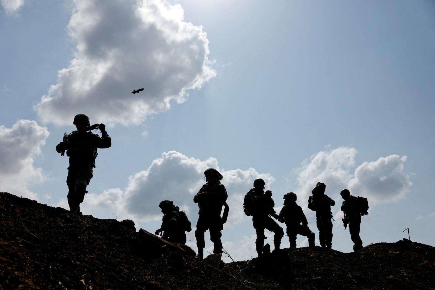 Israeli soldiers gather after the alert of an apparent security incident, in Ashkelon, southern Israel, October 10, 2023.