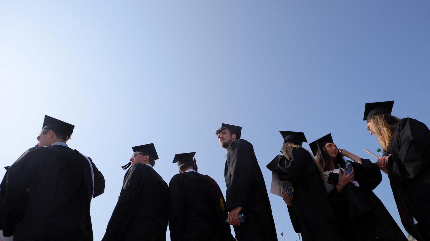 Graduating students gather for Commencement ceremonies at Boston College in Chestnut Hill, Massachusetts, U.S., May 22, 2023. REUTERS/Brian Snyder/File Photo