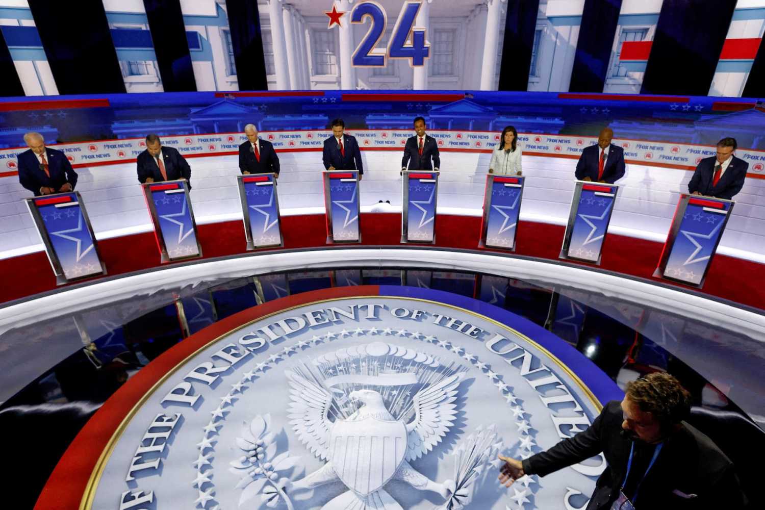 FILE PHOTO: Former Arkansas Governor Asa Hutchinson, former New Jersey Governor Chris Christie, former U.S. Vice President Mike Pence, Florida Governor Ron DeSantis, businessman Vivek Ramaswamy, former South Carolina Governor Nikki Haley, U.S. Senator Tim Scott (R-SC) and North Dakota Governor Doug Burgum debate at the first Republican candidates' debate of the 2024 U.S. presidential campaign in Milwaukee, Wisconsin, U.S. August 23, 2023. REUTERS/Jonathan Ernst/File Photo