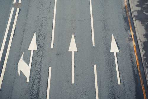 Aerial view of a paved street, three lanes with directional arrows (Credit: Shutterstock/Sergio Photone)