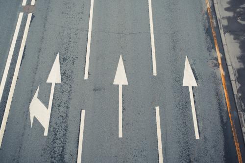 Aerial view of a paved street, three lanes with directional arrows (Credit: Shutterstock/Sergio Photone)