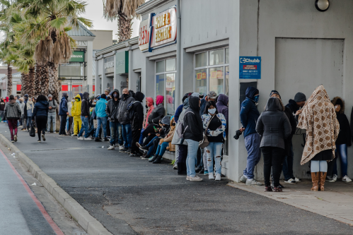 Cape Town, South Africa - August 2020: Covid Relief Funds in South Africa. long lines for people waiting for money to feed themselves. Poverty in Africa. People waiting hours for 20 Dollars.