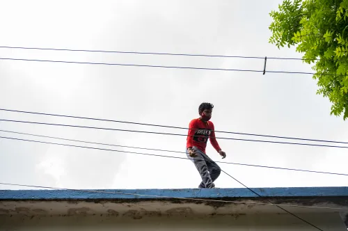 An employee of an Internet wired broadband service provider is providing internet connection through Internet Cable at Tehatta, West Bengal, India on 15 June 2021.