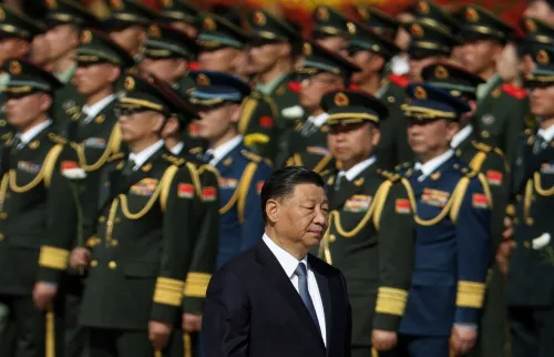 Chinese President Xi Jinping walks past members of the Chinese People's Liberation Army as he arrives for a ceremony to present flowers at the Monument to the People's Heroes to commemorate Martyrs' Day, a day ahead of China's National Day, on Tiananmen Square in Beijing, China September 30, 2023.