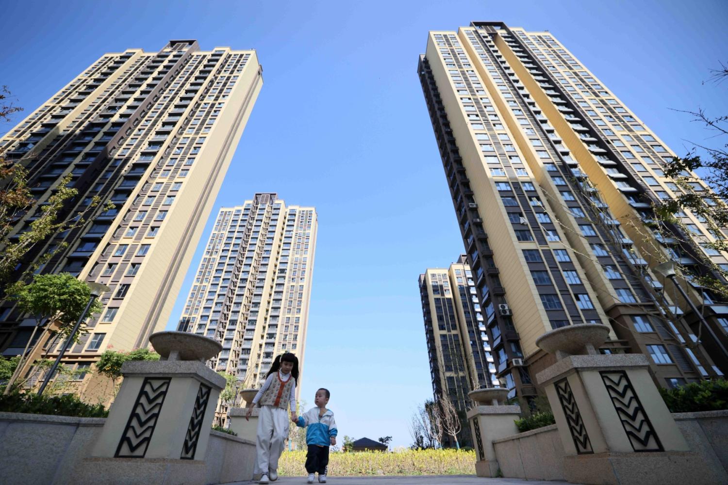 Children play in a residential area at a housing project in Hefei, Anhui province, China, November 1, 2023.