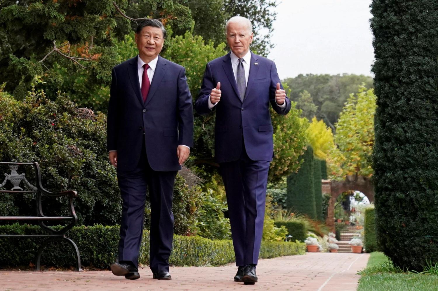 U.S. President Joe Biden gives thumbs-up as he walks with Chinese President Xi Jinping at Filoli estate on the sidelines of the Asia-Pacific Economic Cooperation (APEC) summit, in Woodside, California, U.S., November 15, 2023