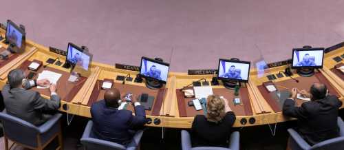 United Nations Security Council members watch as Ukrainian President Volodymyr Zelenskyy, who appears on their screens, addresses the council via video link during a meeting amid Russia's invasion of Ukraine, at the United Nations Headquarters in Manhattan, New York City, New York, U.S., April 5, 2022.