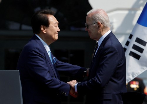 U.S. President Joe Biden and South Korea's President Yoon Suk Yeol shake hands during an official White House State Arrival Ceremony on the South Lawn of the White House in Washington, U.S. April 26, 2023.