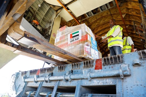 Workers unload aid from World Health Organization and UAE-AID from United Arab Emirates at the Port Sudan International Airport, Port Sudan, Sudan, May 5, 2023.