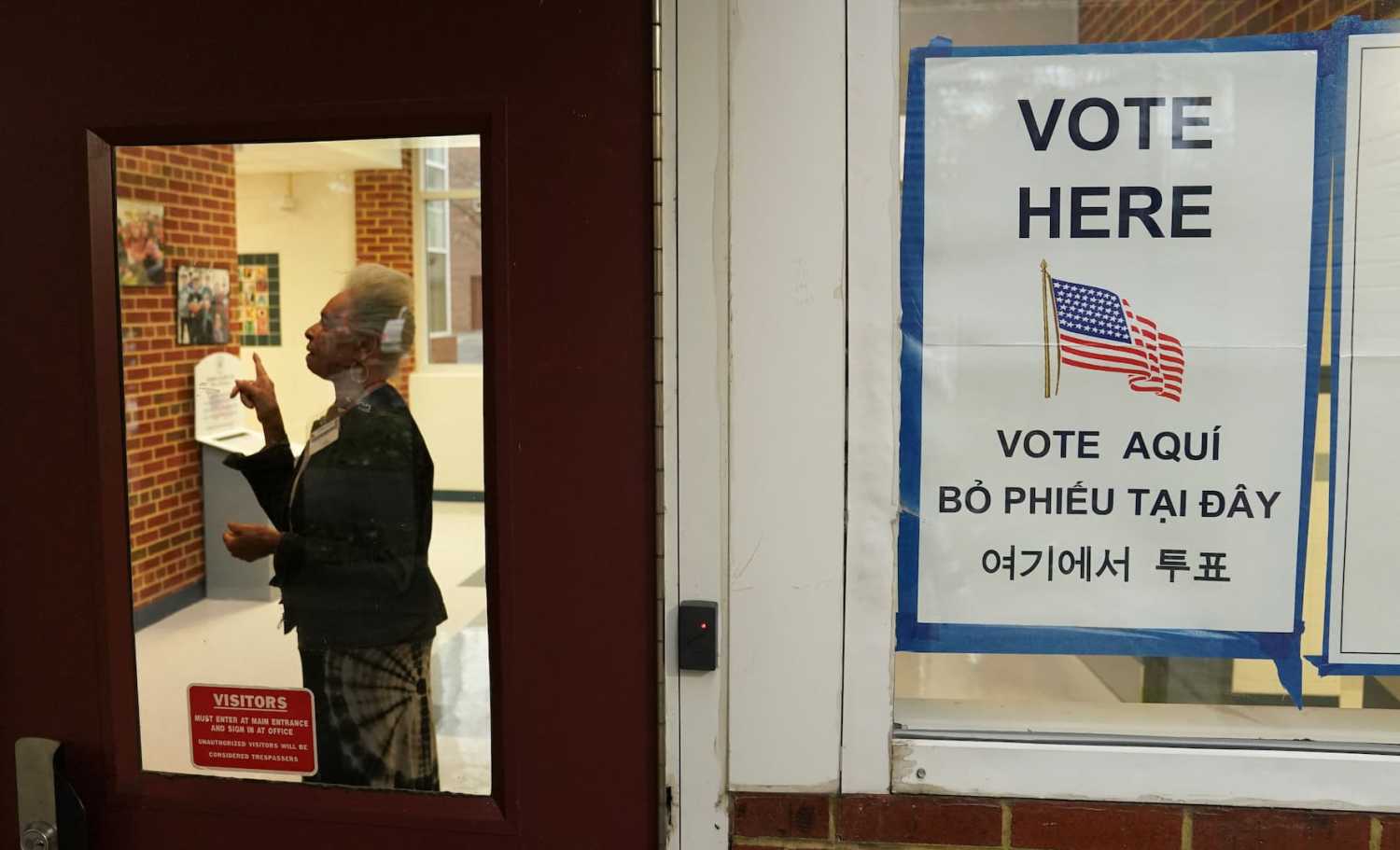 A polling station worker directs a voter to fill out their ballot on Election Day in Falls Church, Virginia, U.S., November 7, 2023. Credit: REUTERS/Kevin Lamarque