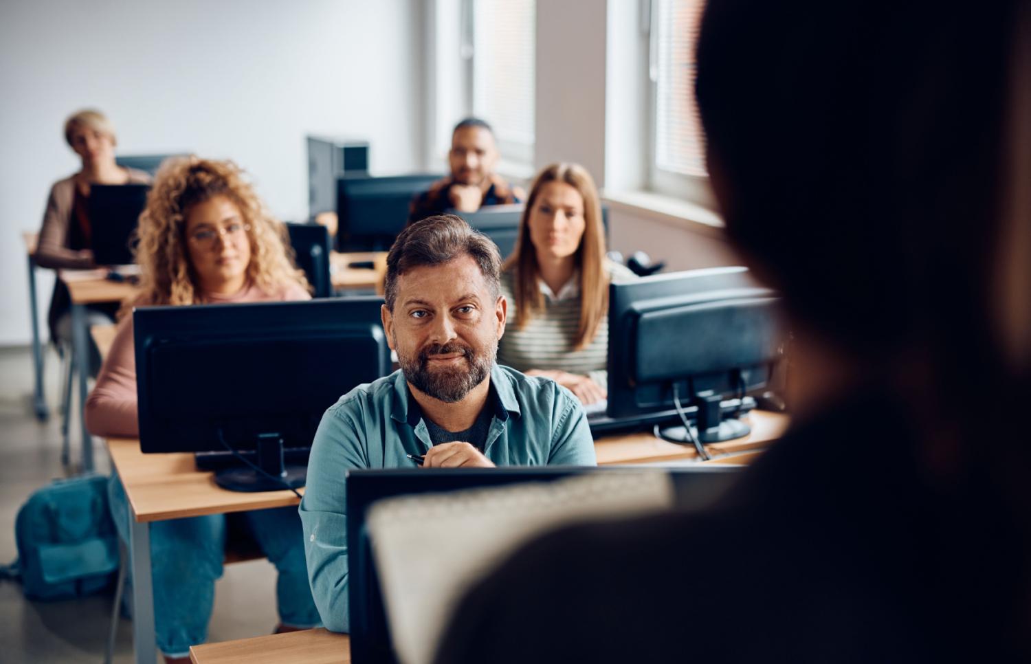 Adult students sit in a college classroom