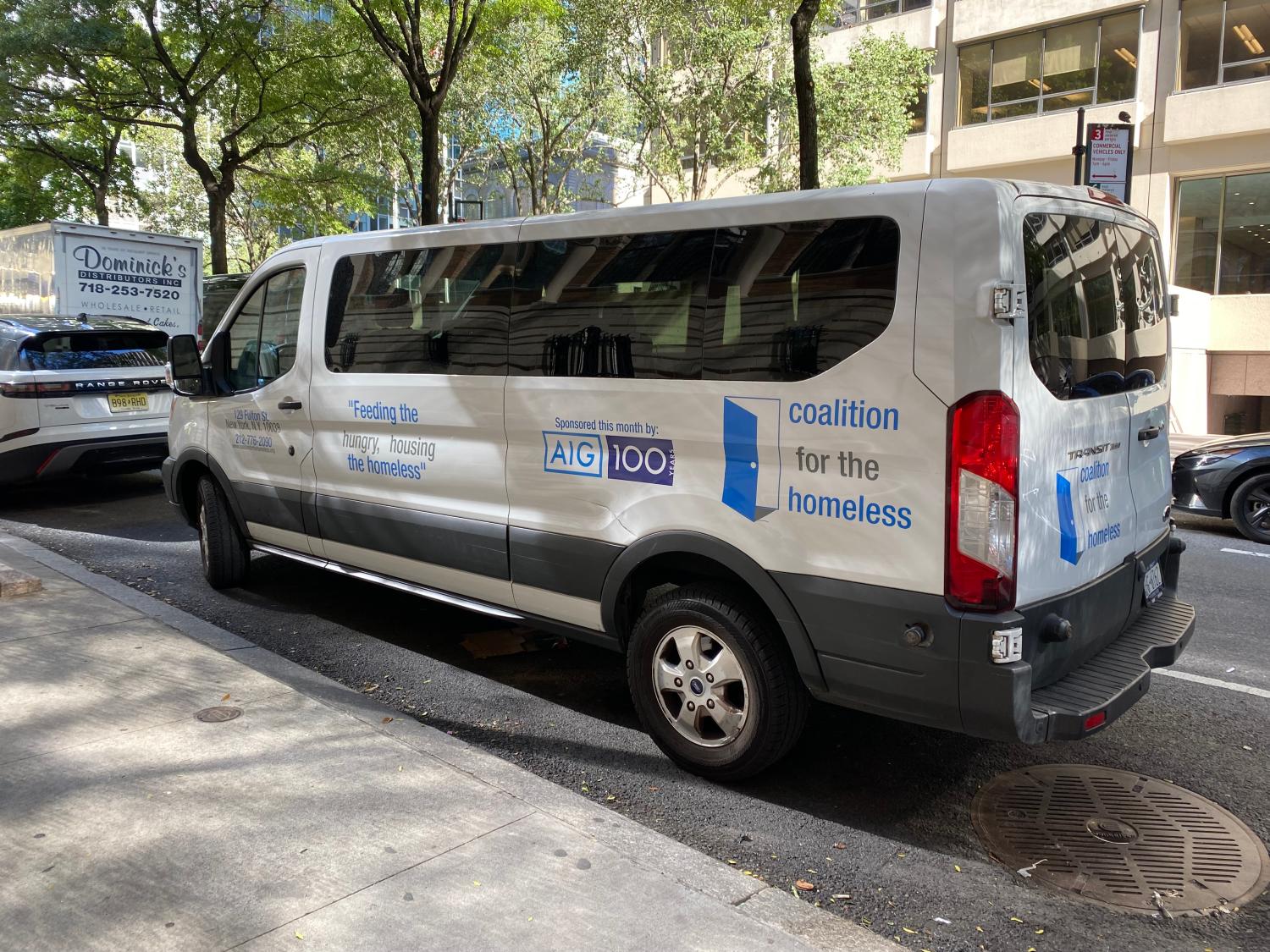 coalition for homeless van parked on the street with the quoate "Feeding the hungry, housing the homeless: on the side