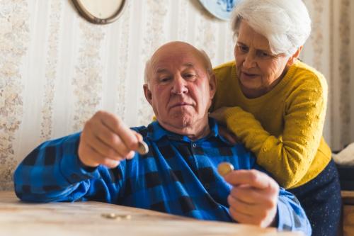 Elderly couple counting money