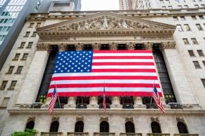 Large American flag hanging on the New York Stock Exchange building