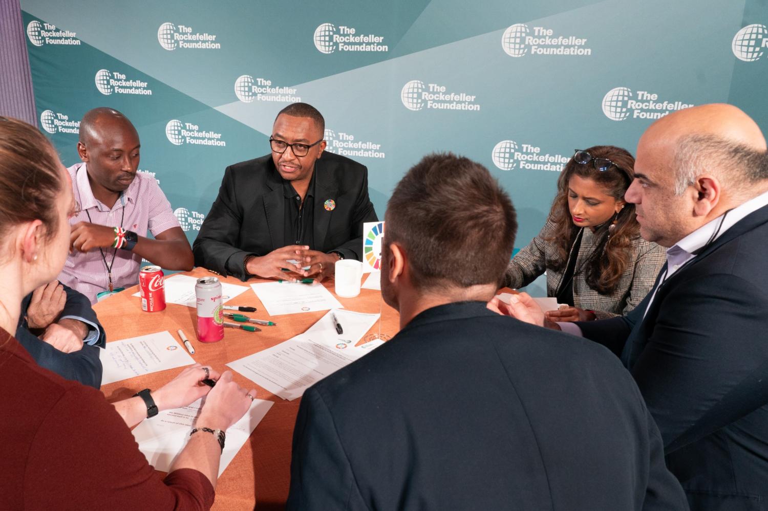 17 Rooms participants, including (left to right) James Muraguri, David Kamau, Tina George Karippacheril, and Kobe Nagar, engage in small group discussion during the September community gathering. Photo by Ralph Alswang (on behalf of The Rockefeller Foundation).