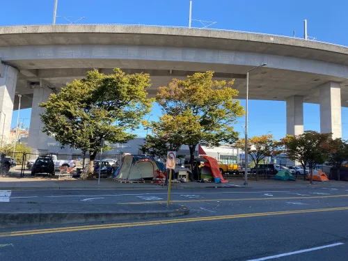 homeless tents under a downtown bridge