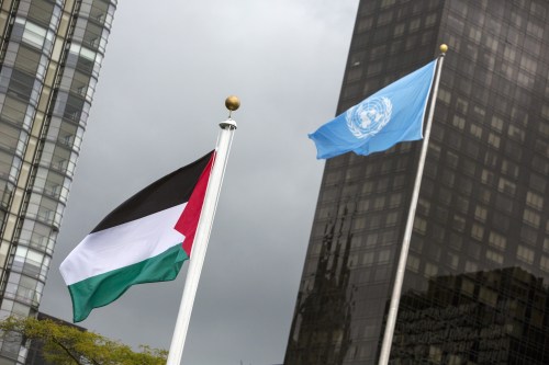 The Palestinian flag flies beside the flag of the United Nations after being raised by Palestinian President Mahmoud Abbas in a ceremony during the United Nations General Assembly
