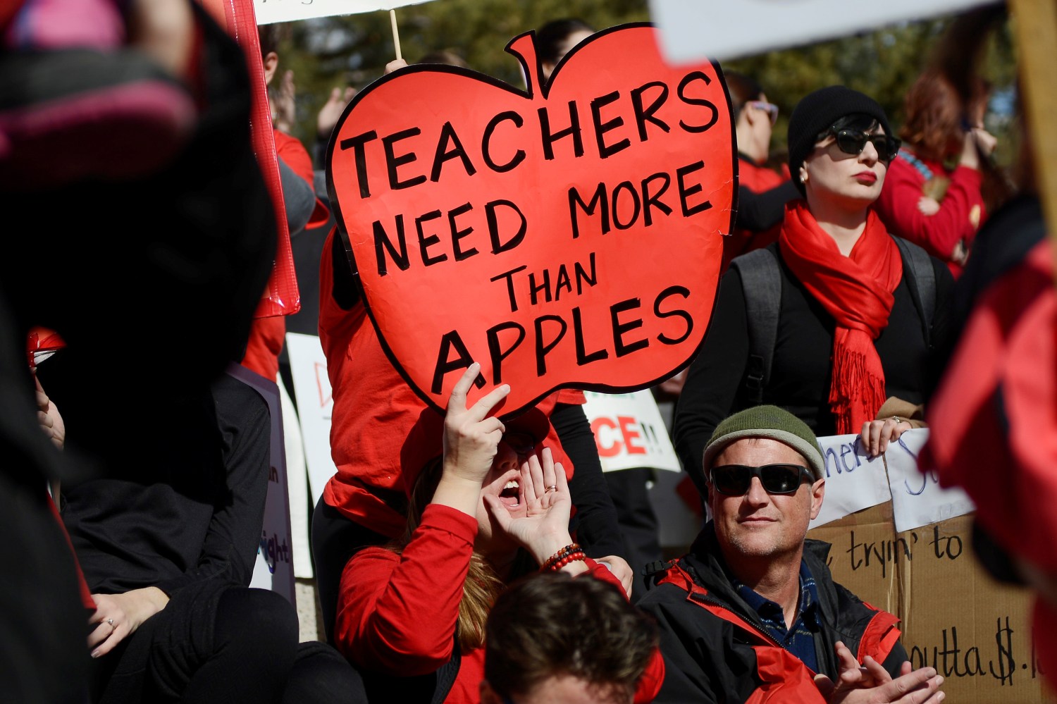 Munroe Elementary teacher Melissa Curry holds a sign during a rally across from the Colorado State Capitol as Denver public school teachers strike for a second day in Denver, Colorado, U.S., February 12, 2019.