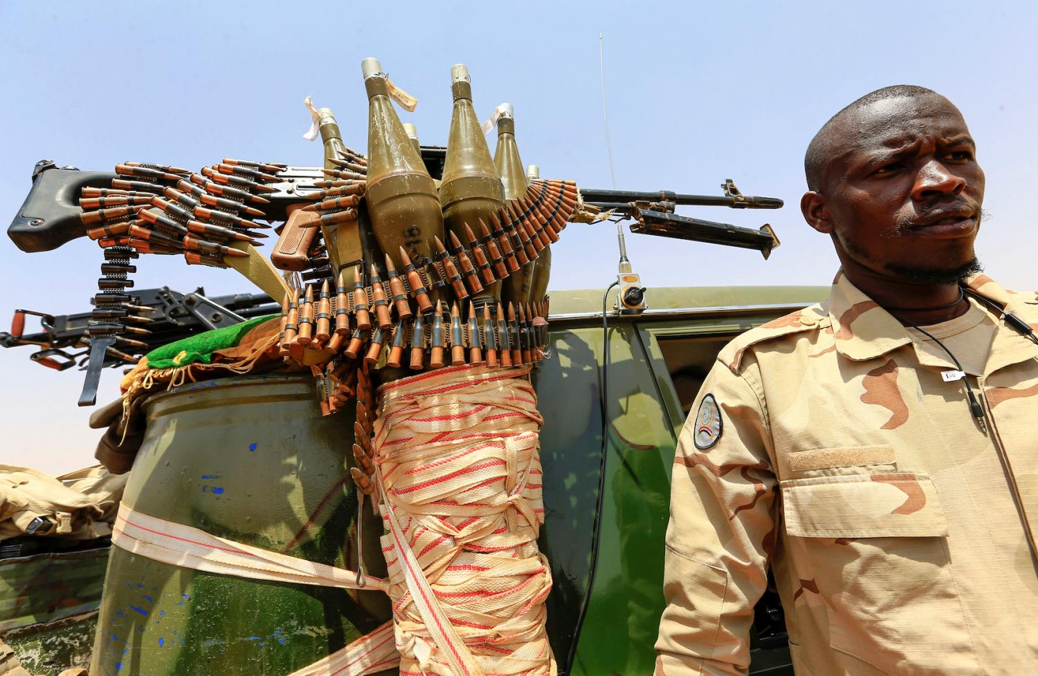 A member Sudan's paramilitary Rapid Support Forces (RSF) stand next to a vehicle during an operation to locate and arrest Irregular migrants from Ethiopia, Sudan and Chad who were abandoned by traffickers in a remote desert area near the Libyan border and taken to the Khartoum State border, Sudan September 25, 2019.