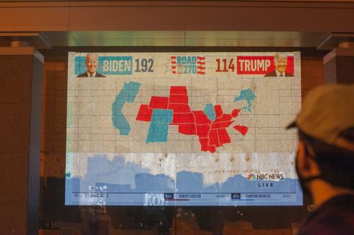 Protesters and residents of Washington DC watch as election results come in on projectors by the White House on November 3, 2020 in Washington DC, US.