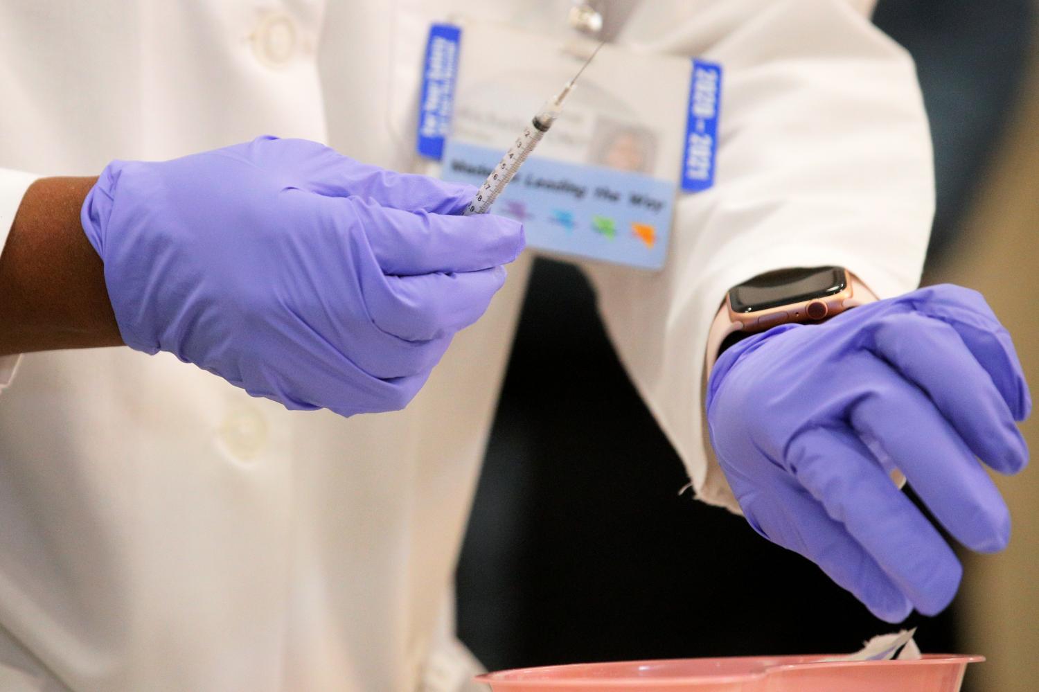 Dr Michelle Chester from Northwell Health prepares to administer a Pfizer coronavirus disease (COVID-19) vaccine at Long Island Jewish Medical Center in New Hyde Park, New York.