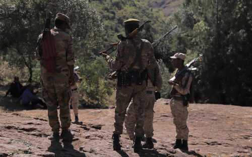Members of the Amhara Special Forces stand guard next to the Saint George rock-hewn church in the Lalibela town of the Amhara Region, Ethiopia, January 25, 2022.