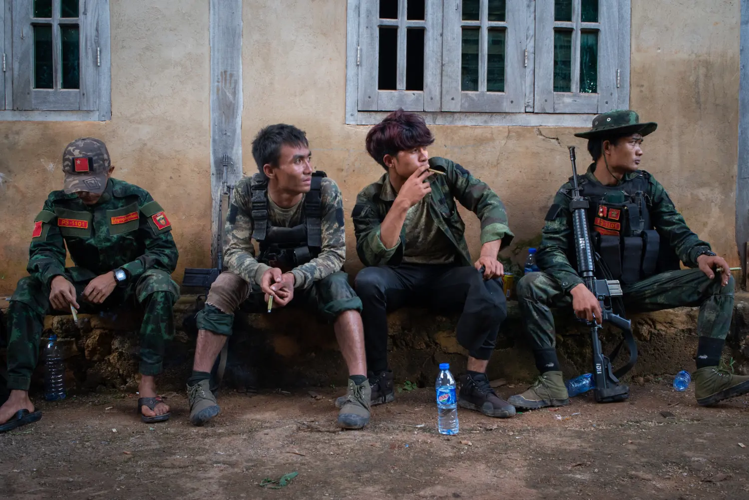 Resistance force servicemen take a break during the 1111 operation, where they were involved in a battle against the military junta in Demoso township.