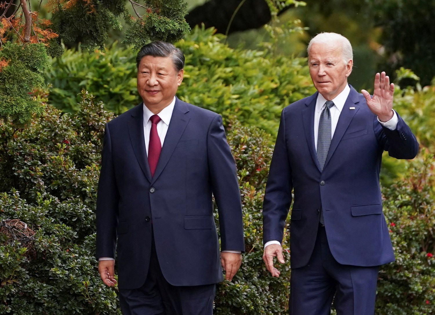 U.S. President Joe Biden waves as he walks with Chinese President Xi Jinping at Filoli estate on the sidelines of the Asia-Pacific Economic Cooperation (APEC) summit, in Woodside, California, U.S., November 15, 2023.