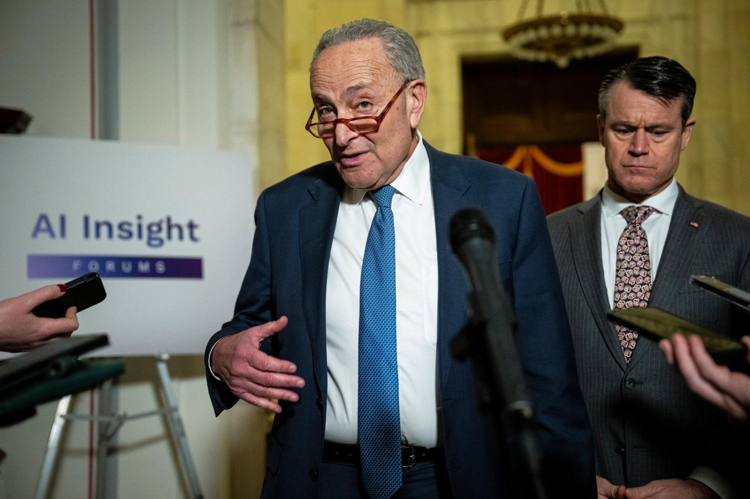 Senator Chuck Schumer (D-NY), the Senate Majority Leader, and Senator Todd Young (R-IN) speak to media after the conclusion of an Artificial Intelligence Insight Forum that focused on transparency, explainability, intellectual property, and copyright, at the U.S. Capitol, in Washington, D.C., on Wednesday, November 29, 2023.