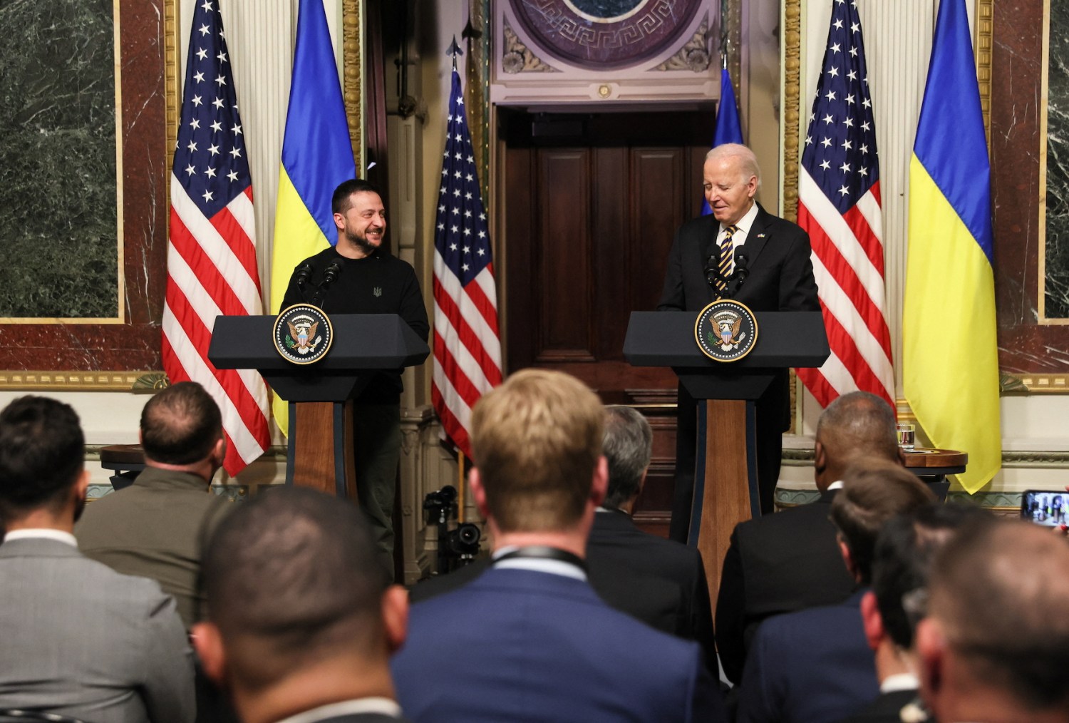 U.S. President Joe Biden and Ukraine's President Volodymyr Zelenskiy react during a joint press conference at the White House in Washington, U.S., December 12, 2023.