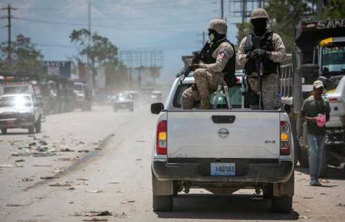 In 2022, Haiti police on patrol keep their eyes on traffic during a stop at a police checkpoint in Tabarre, near the U.S. Embassy, east of metropolitan Port-au-Prince. Gangs have taken control of neighborhoods in the vicinity. (José A. Iglesias/Miami Herald/TNS/ABACAPRESS.COM)