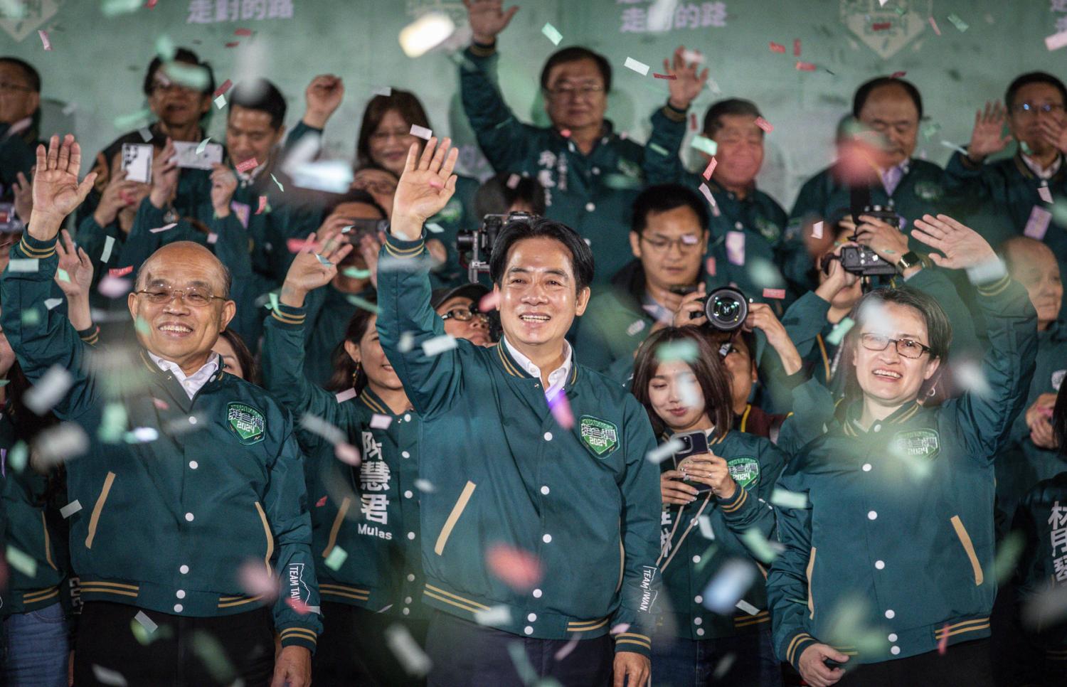 President-elect Lai Ching-te (L2) and Vice President-elect Hsiao Bi-khim (L3) of the Democratic Progressive Party wave to supporters after winning the election in Taipei, Taiwan on the evening of January 13, 2024.