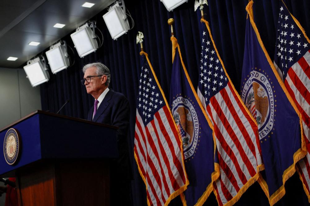 Federal Reserve chairman Jerome Powell speaks in front of Federal Reserve and U.S. flags.