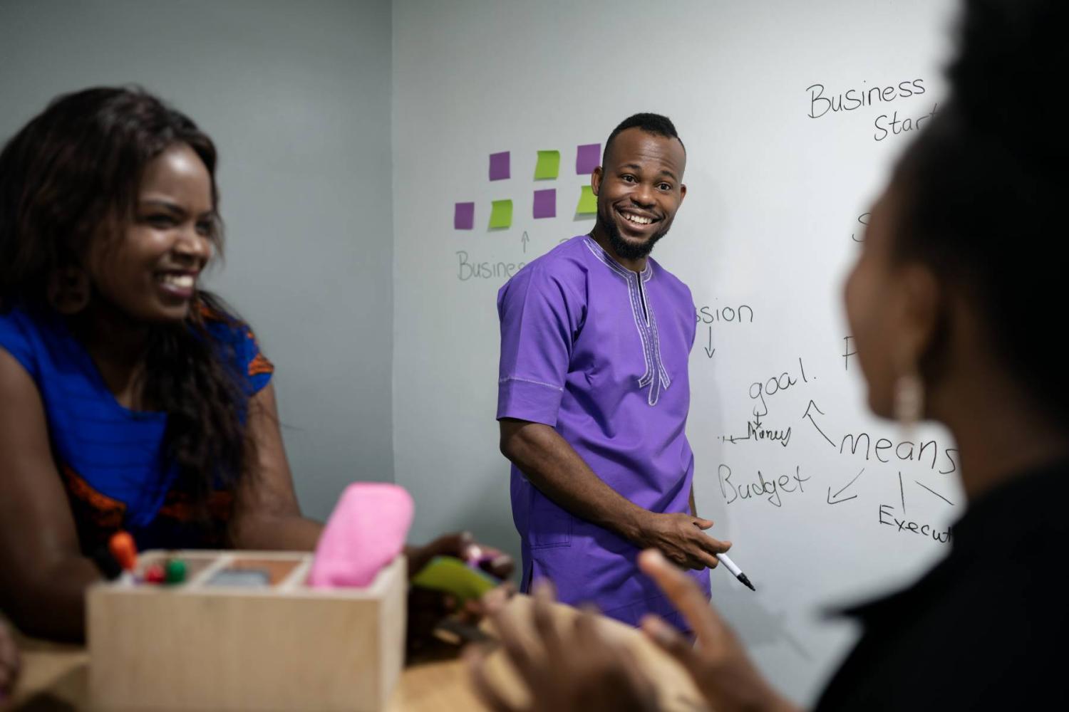 Young African business people brainstorm in an office (Photo credit: Jono Erasmus / Shutterstock)