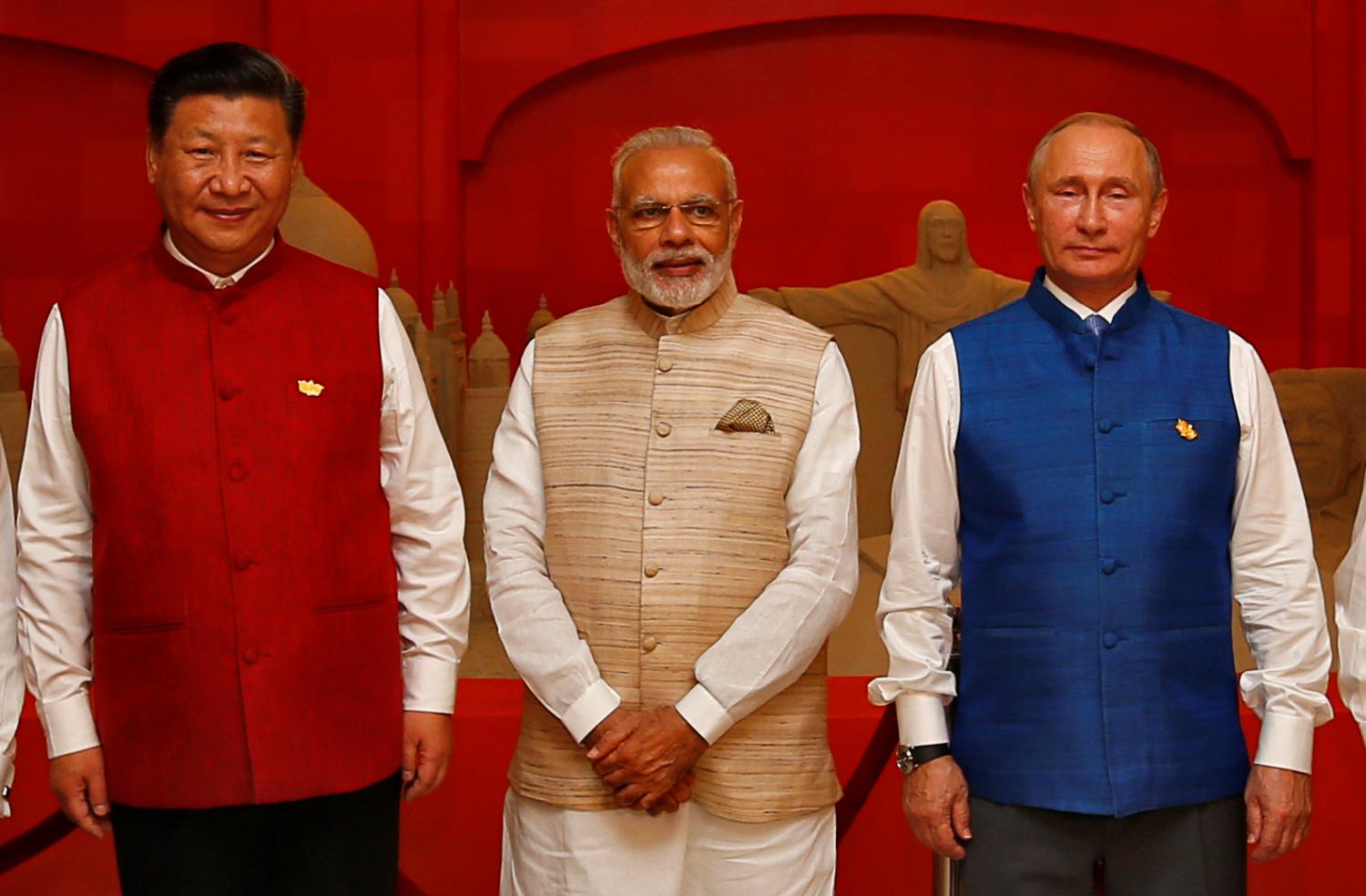 Chinese President Xi Jinping, Indian Prime Minister Narendra Modi and Russian President Vladimir Putin pose infront of a sand sculpture ahead of BRICS Summit in Benaulim, in the western state of Goa