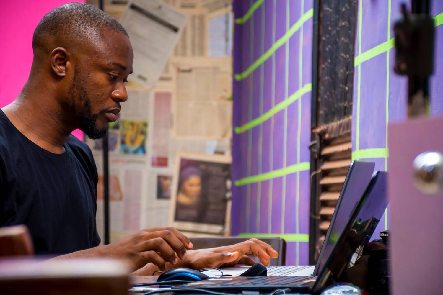 A young African man works on a laptop in his office. (Photo credit: courage007 / Shutterstock)