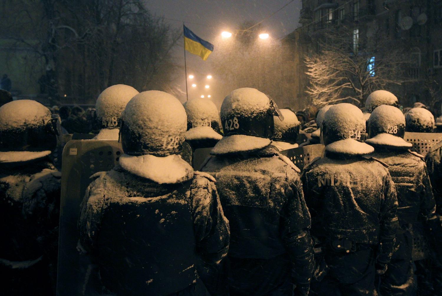 Interior Ministry personnel block a street during a gathering of supporters of EU integration in Kyiv, December 9, 2013.