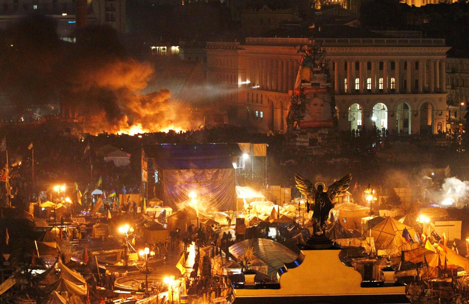 Smoke rises above burning barricades at Independence Square during anti-government protests in Kyiv, February 20, 2014.