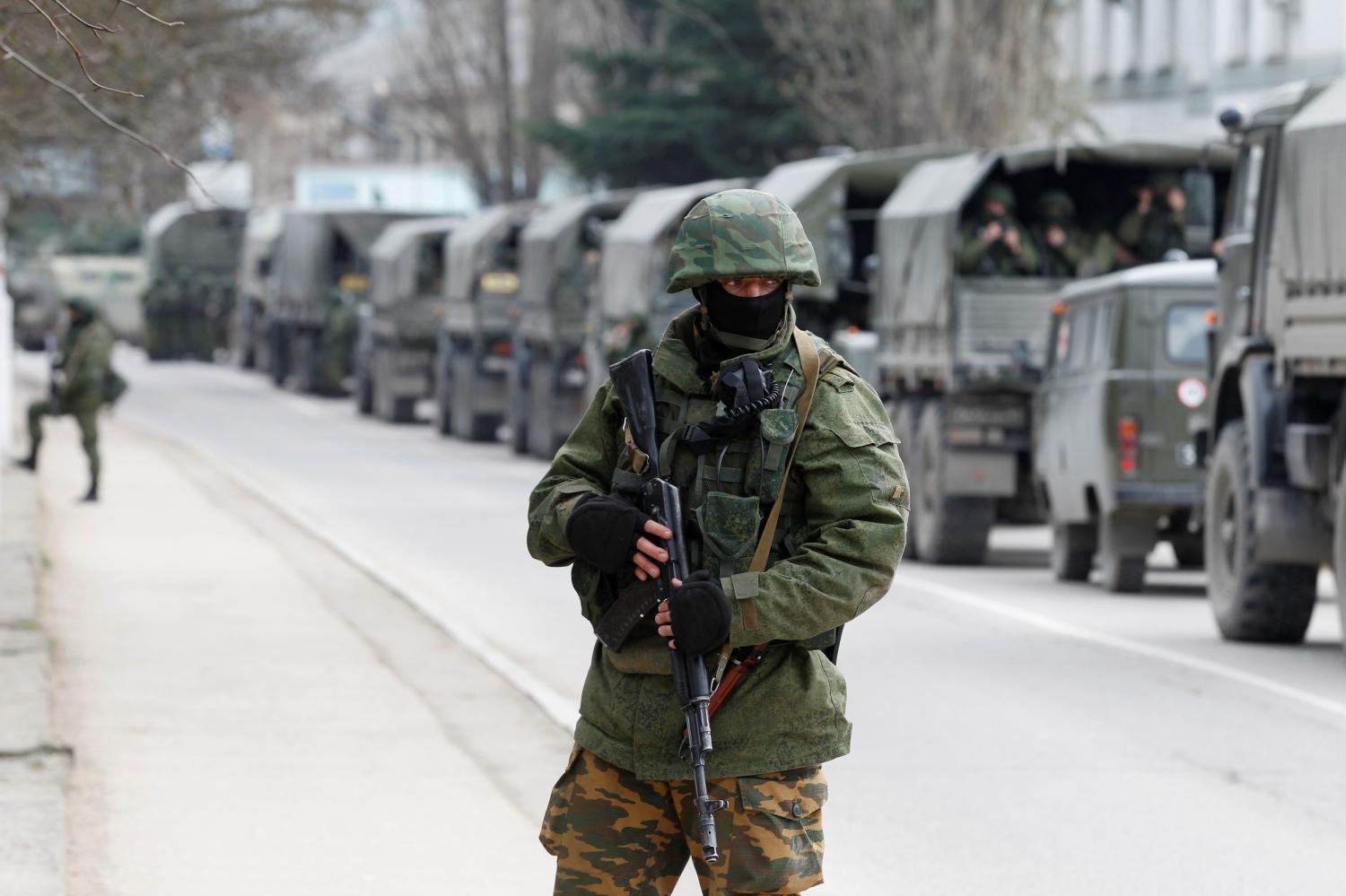 Armed servicemen wait in Russian army vehicles outside a Ukrainian border guard post in the Crimean town of Balaclava, March 1, 2014.