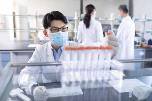 Chinese scientists examining medical sample in laboratory Beijing, China.