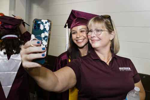 Riverview High School graduate Nobile Shelby takes a selfie with her guidance counselor, Kathryn Sperber, at Saturday's commencement ceremony at Robarts Arena on May 21, 2023.