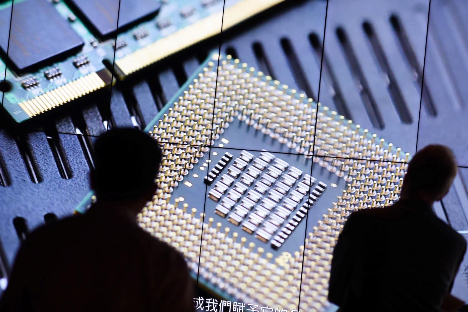 A visitor of the TSMC Museum of Innovation watches a promotional video explaining how the Taiwan Semiconductor Manufacturing Company (TSMC) manufactures its integrated circuits and wafer semiconductor devices.