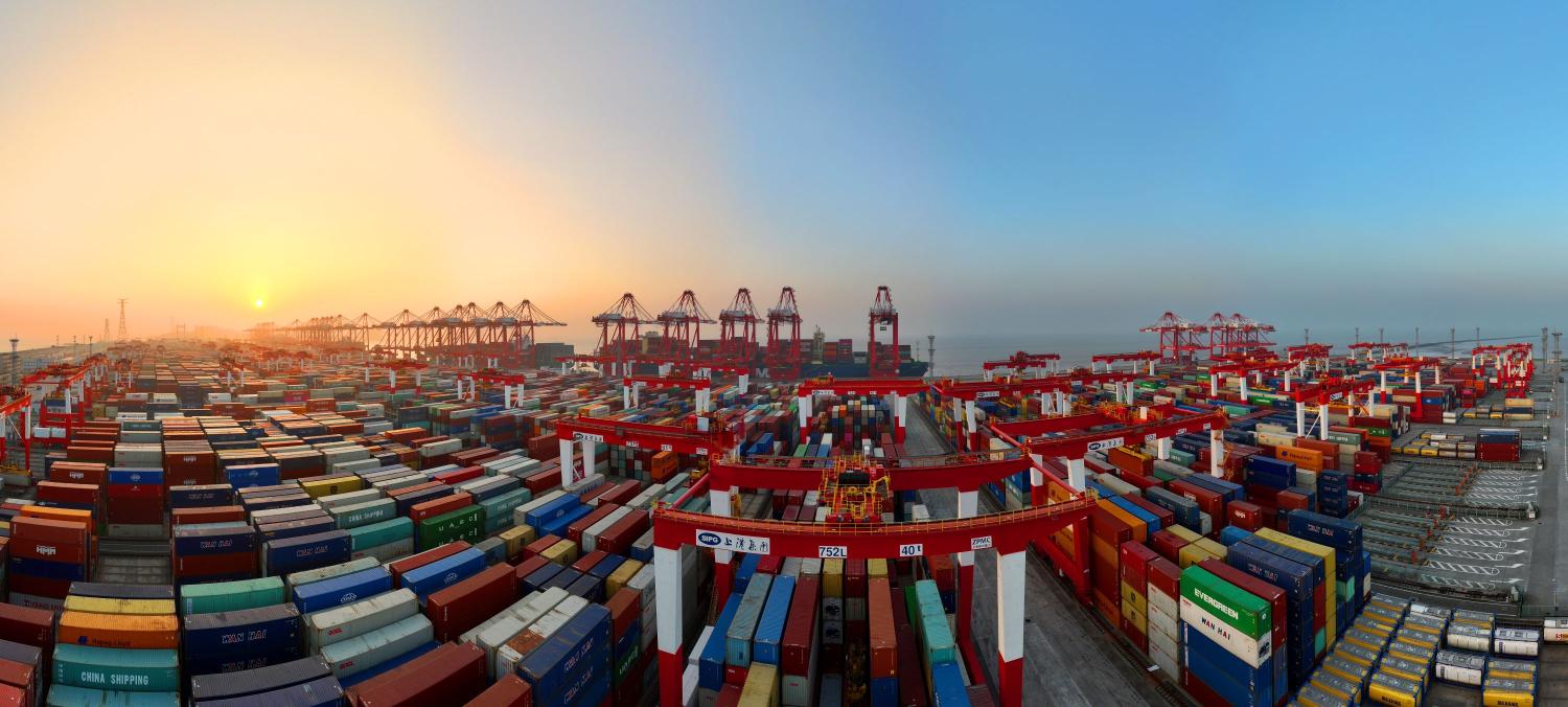 An ultra-large cargo ship carries out container handling operations at the automated terminal of Yangshan deep-water Port in Shanghai, China, Jan 1, 2024.