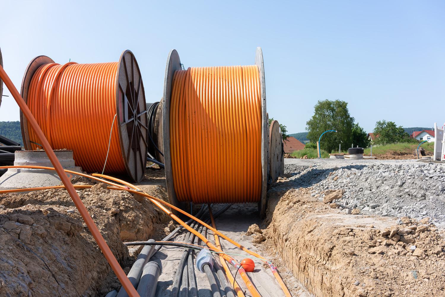 Orange broadband cable is laid in a new development area.